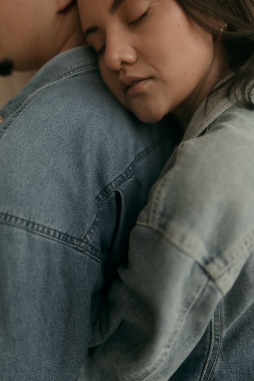 Free A close-up shot of a couple embracing, both wearing denim jackets, conveying warmth and intimacy. Stock Photo