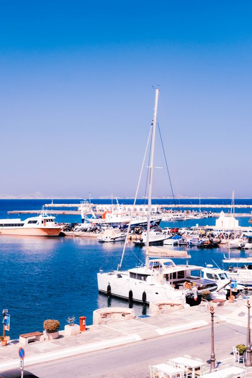 Free Scenic view of a vibrant marina with yachts and blue waters on a sunny day, perfect for summer travel inspiration. Stock Photo