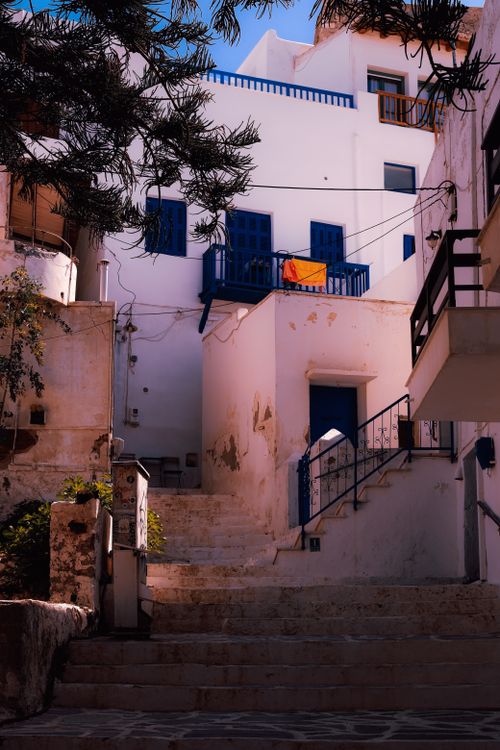 Free Sunlit stairway in a traditional Mediterranean town with blue accents on white buildings. Stock Photo