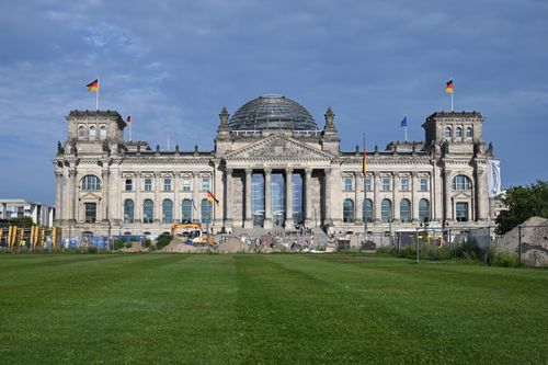 Free The Reichstag building in Berlin, known for its iconic glass dome, under a clear sky. Stock Photo