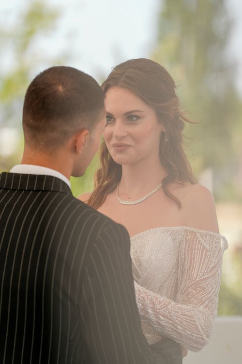 Free Couple exchanging vows outdoors during a romantic wedding ceremony. Stock Photo