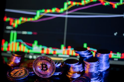Free Golden Bitcoins in front of a financial graph, illustrating cryptocurrency markets and investment trends. Stock Photo