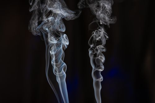Free Abstract artistic smoke wisps creating ethereal shapes against a dark background. Stock Photo