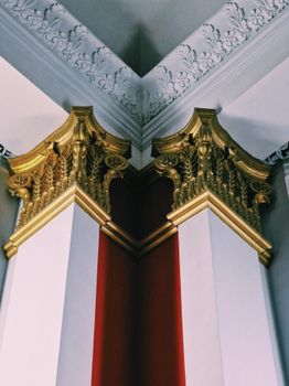 Elegant corner with golden architectural elements and ornate molding details.