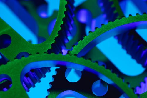 Free Detailed macro shot of colorful interlocking gears in a vibrant industrial setting. Stock Photo