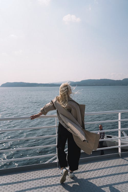 Free Woman Standing By The Side Of A Watercraft Stock Photo