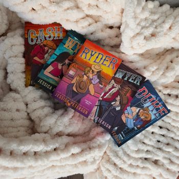Vibrant book covers laid on a soft, textured white blanket, creating a cozy atmosphere.（イメージ）