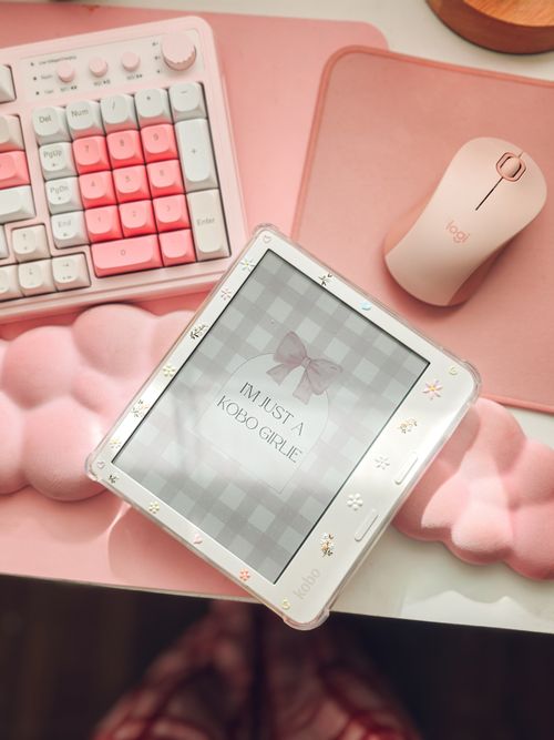 Free Modern pink-themed desk setup featuring a keyboard, mouse, and tablet with a stylish cover. Stock Photo
