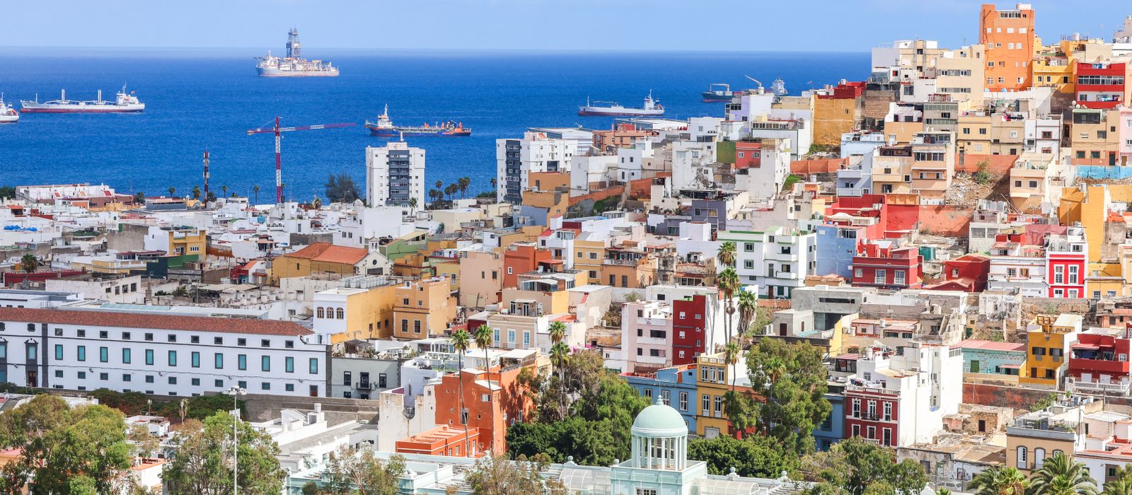 Aerial view of vibrant Las Palmas de Gran Canaria with ships in the Atlantic Ocean.