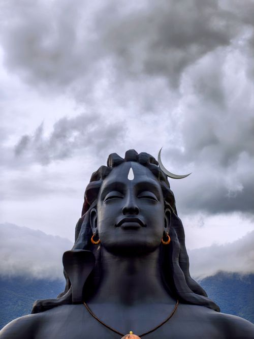 Free A breathtaking view of the Adiyogi Shiva statue under dramatic clouds in Semmedu, India. Stock Photo