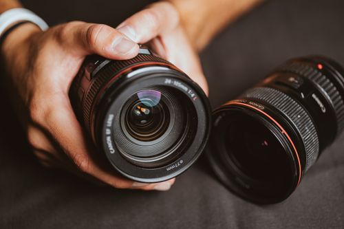 Free Detailed image of hands holding camera lenses, showcasing precision optics. Stock Photo