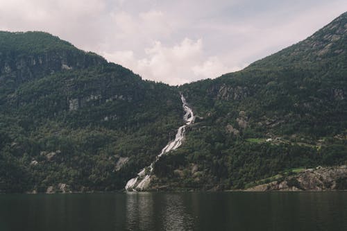 Green Mountain Beside Body Of Water