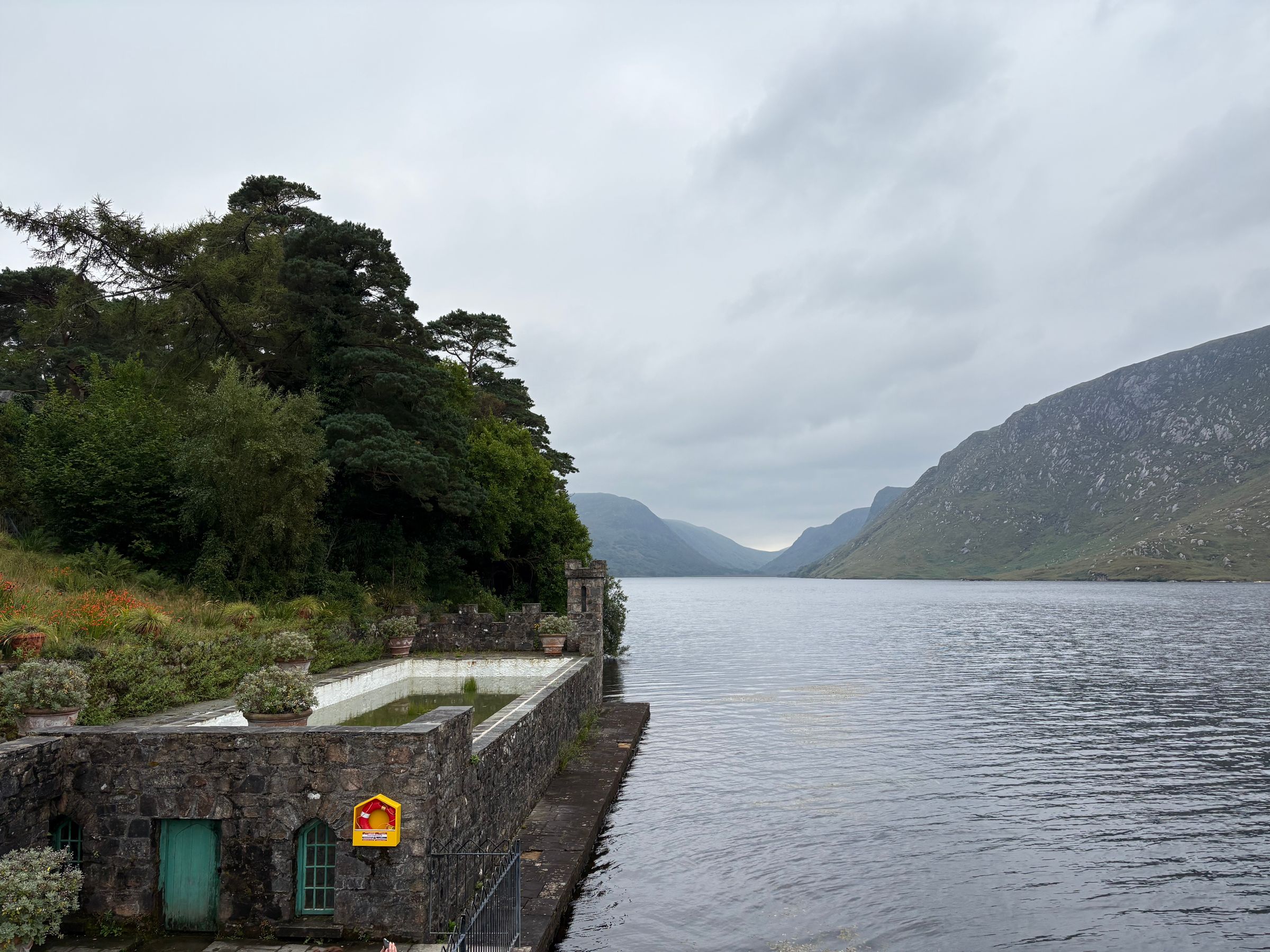 Peaceful lake with mountain backdrop and greenery in County Donegal, Ireland