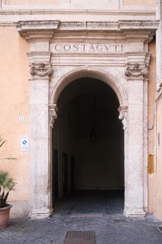 Elegant stone archway in Rome's historical district, showcasing classical architecture.