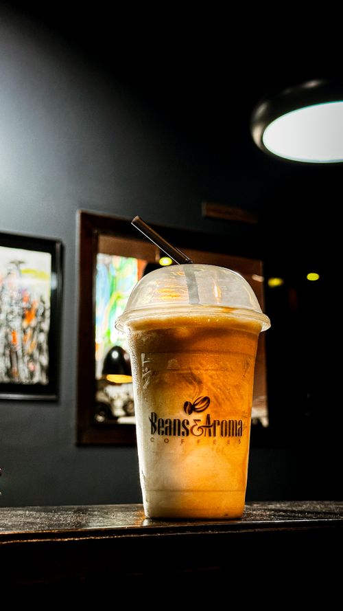 Free Chilled coffee beverage in a modern cafe, highlighting an artistic background and dim ambiance. Stock Photo