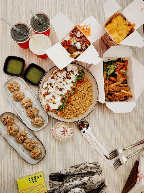 Free Overhead view of diverse Asian dishes with beverages on a table, perfect for food enthusiasts. Stock Photo
