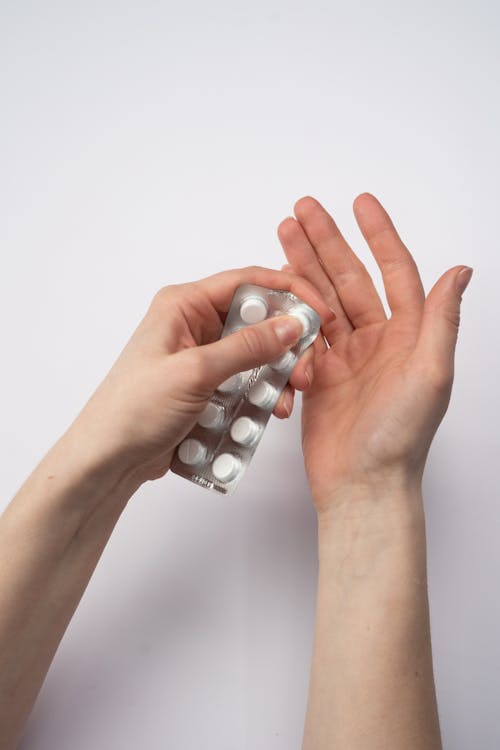 Free Person Holding Silver Blister Pack Stock Photo
