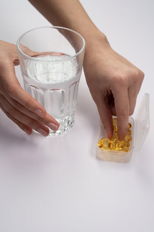 Person Holding Clear Drinking Glass 