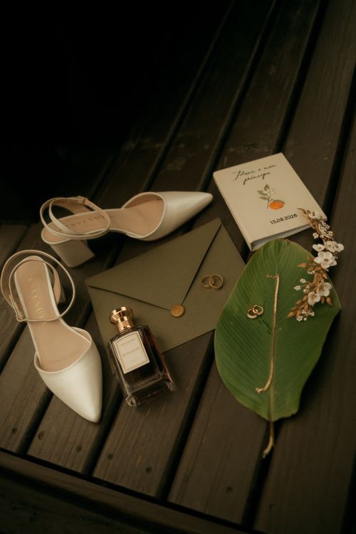 Free Stylish wedding flat lay showcasing elegant shoes, perfume, invitation, and jewelry. Stock Photo