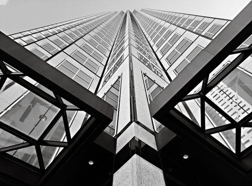 Free Striking black and white image of a skyscraper from a low angle, showcasing modern architectural design. Stock Photo