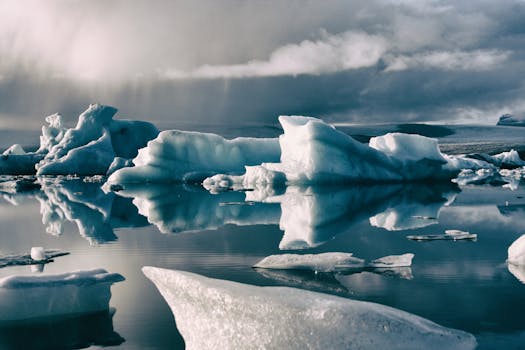 A breathtaking view of icebergs reflecting in crystal clear water, captured in Iceland.