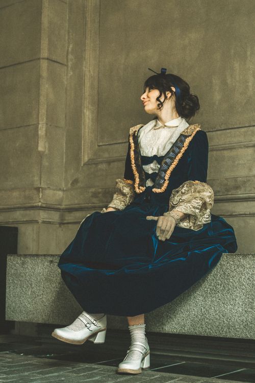 Free Elegant portrait of a person in Victorian-style attire sitting indoors, Buenos Aires. Stock Photo