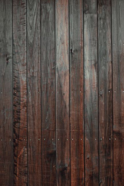 High-quality image of a rustic wooden wall panel with a dark, vintage style.