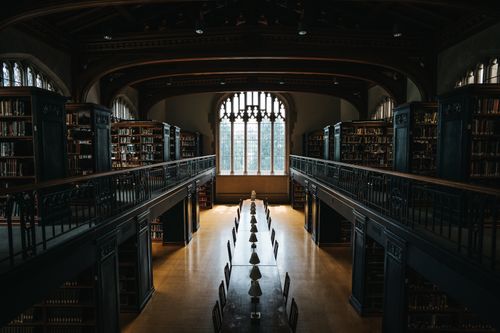 Free Historic gothic-style library interior at Vassar College, New York, with ambient lighting and quiet atmosphere. Stock Photo