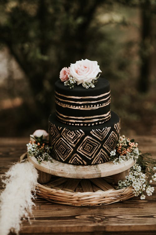 Free Black Round Cake With Gold Details On Brown Wooden Table Stock Photo