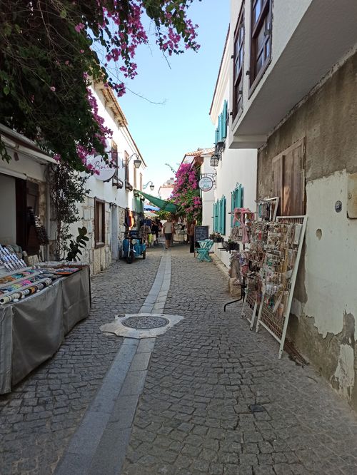 Free A picturesque street with local shops and decorations, perfect for travel and lifestyle themes. Stock Photo