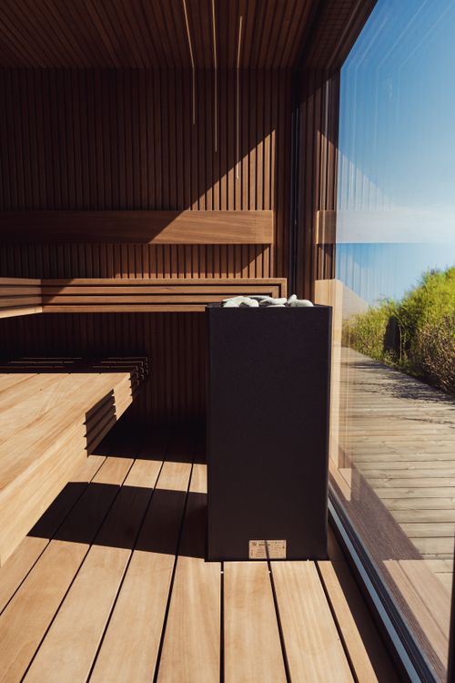 Free A contemporary sauna with stunning outdoor views, featuring sleek wooden design and modern heater. Stock Photo