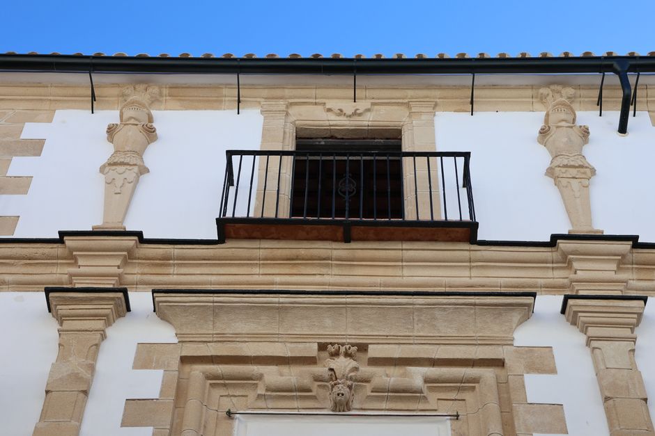 Detailed facade with sculptures and balcony in El Puerto de Santa María, Spain.