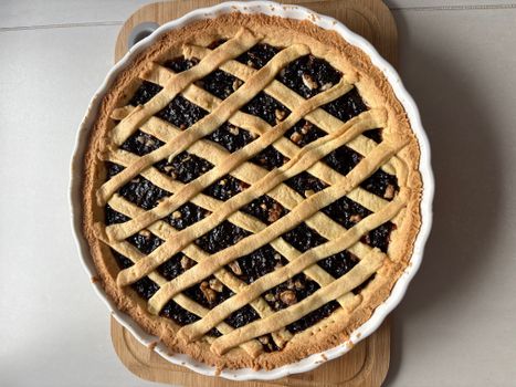 Top view of a freshly baked lattice cherry pie with golden crust.