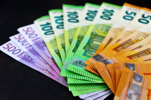 Close-up of colorful euro banknotes fanned out, showcasing currency and financial themes.
