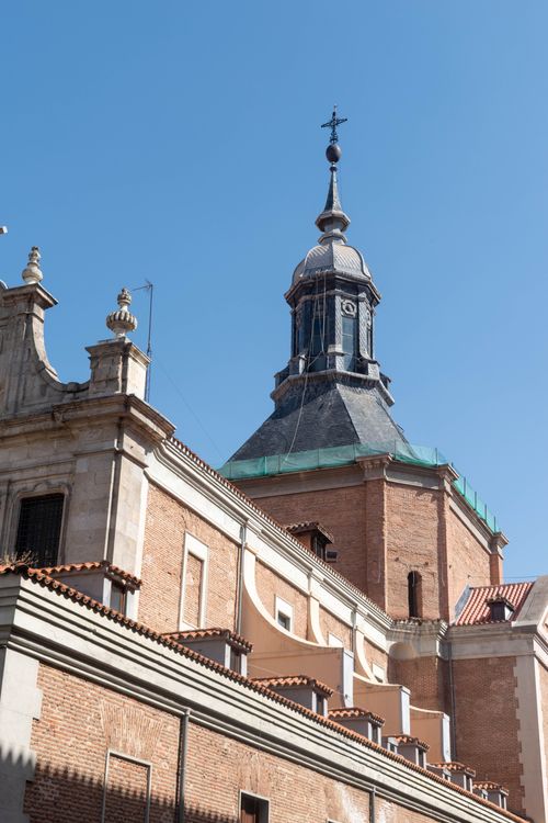 Free Elegant church architecture with a prominent tower set against a clear blue sky, showcasing historical design. Stock Photo