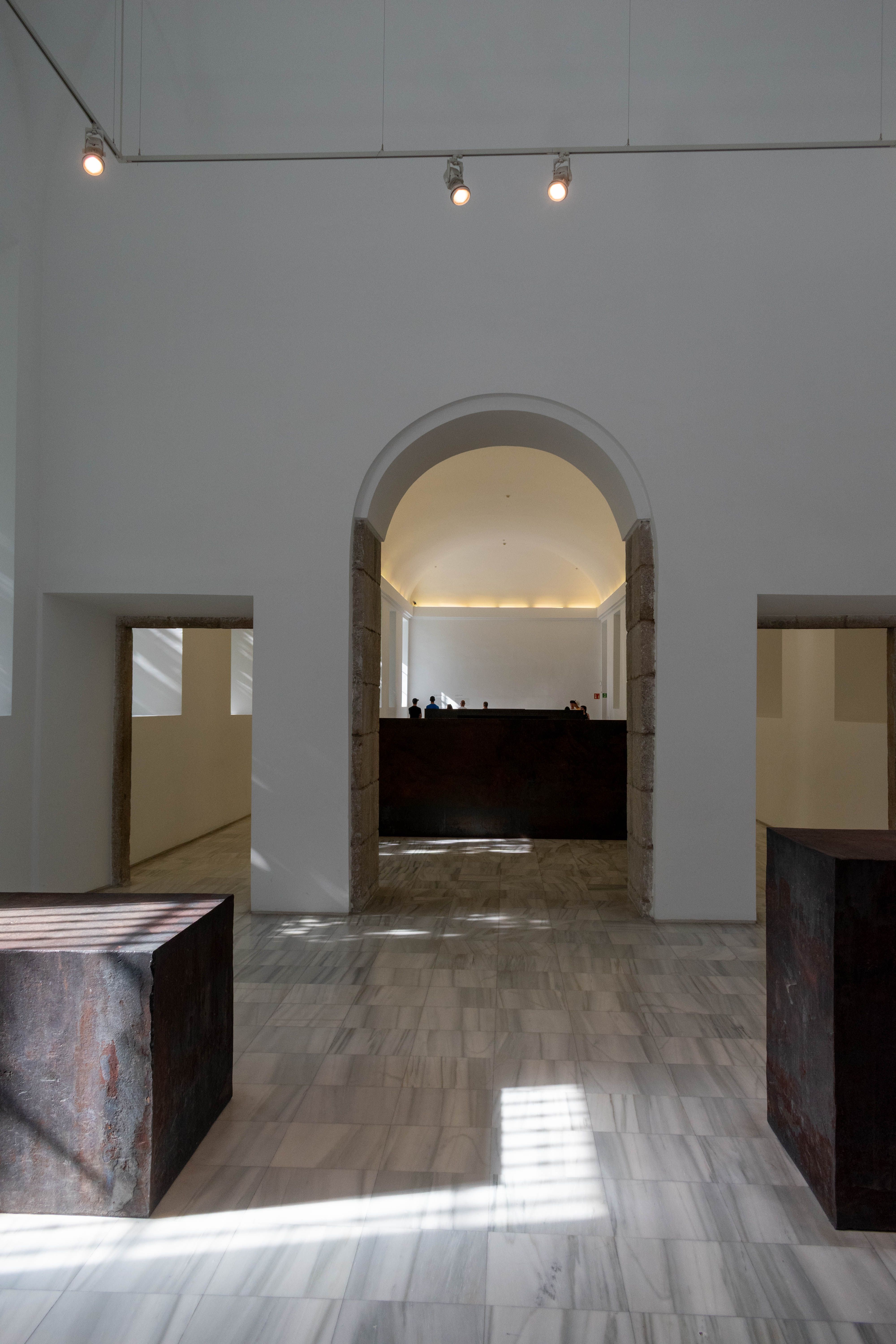 Minimalist archway with stone floor at the studio entrance