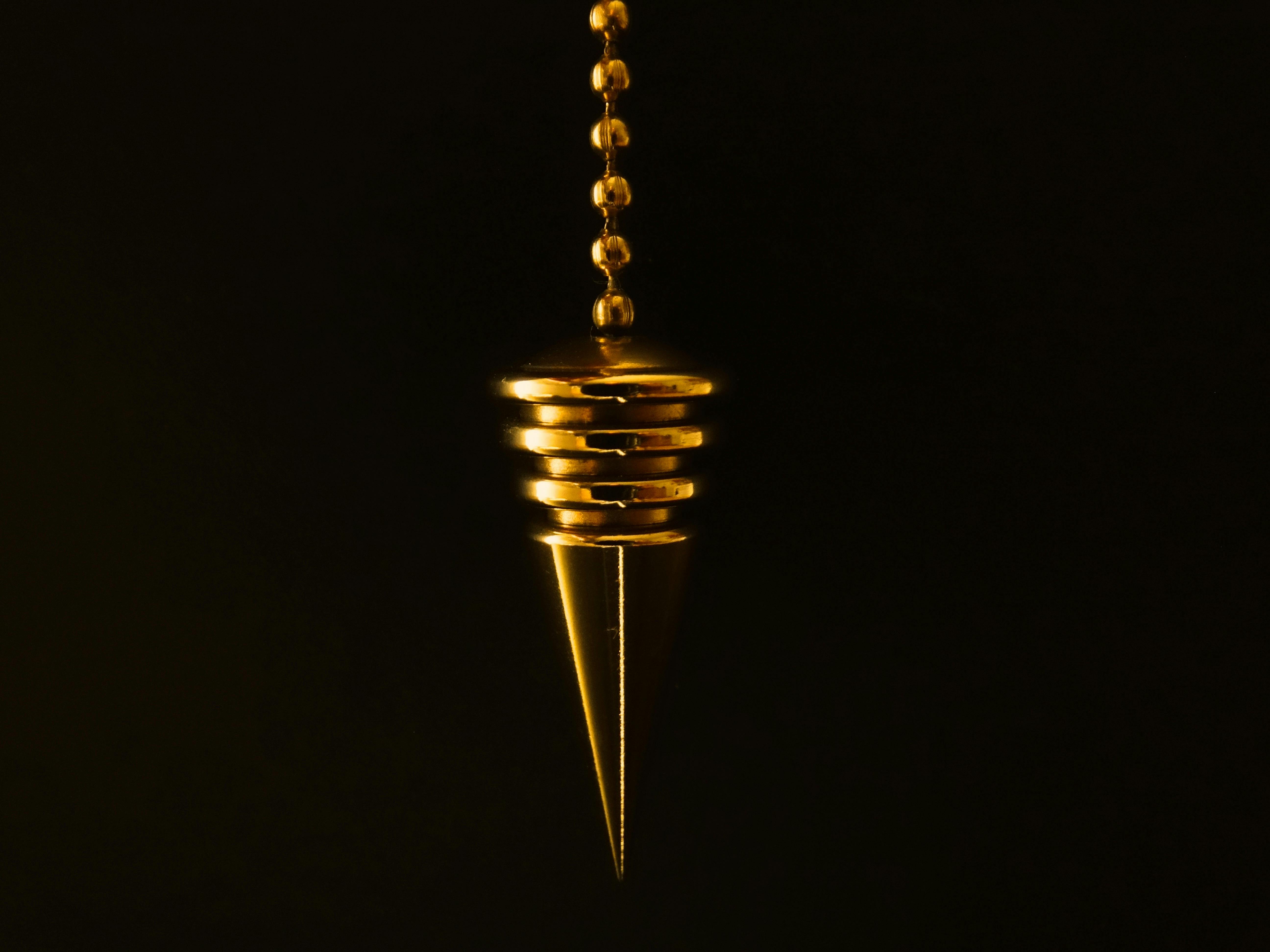 hanging gold colored pendant with necklace