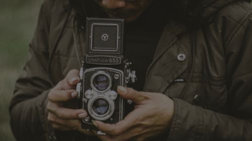 Free Close-up of hands holding a vintage Yashica 635 camera in Malang, Indonesia. Stock Photo