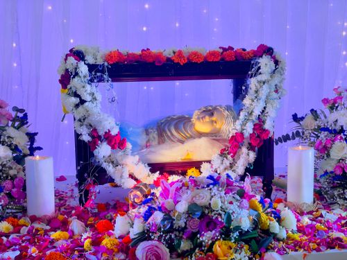 Free Ornate altar adorned with colorful flowers and a religious statue, illuminated in soft ambient light. Stock Photo