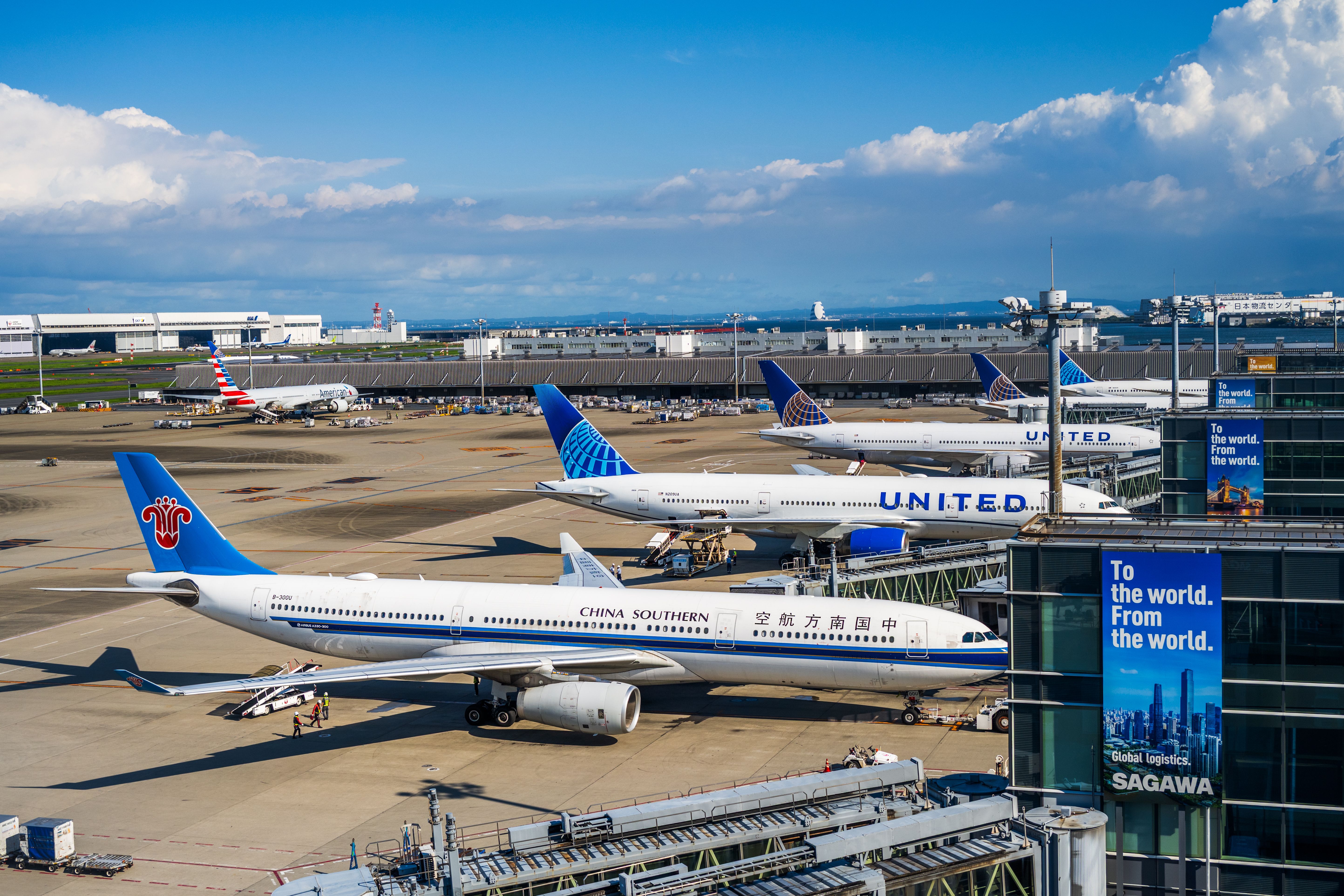 Busy runway at Narita International Airport featuring China Southern and United planes.