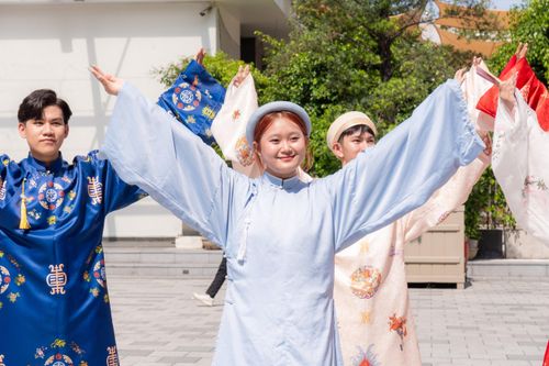 Free Youth dressed in vibrant traditional attire performing a dance outdoors in sunlight. Stock Photo