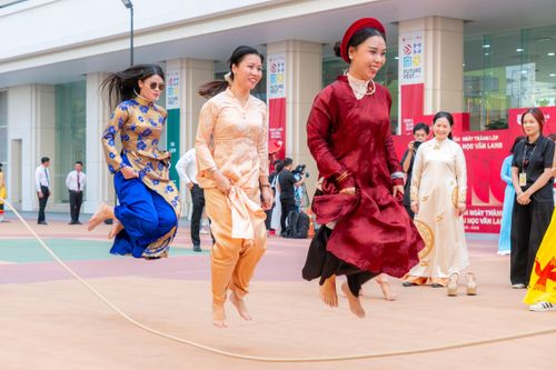 Free Women in traditional attire joyfully participate in a lively outdoor cultural dance event. Stock Photo