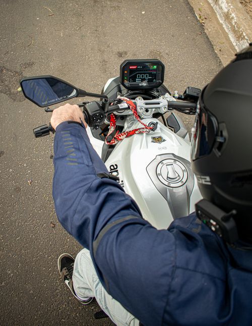 Free Top view of motorcyclist riding on an urban road, showcasing the motorcycle dashboard and controls. Stock Photo