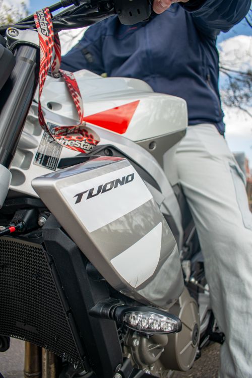 Free A close-up angle of a motorcycle with a rider in casual wear, showcasing modern design. Stock Photo