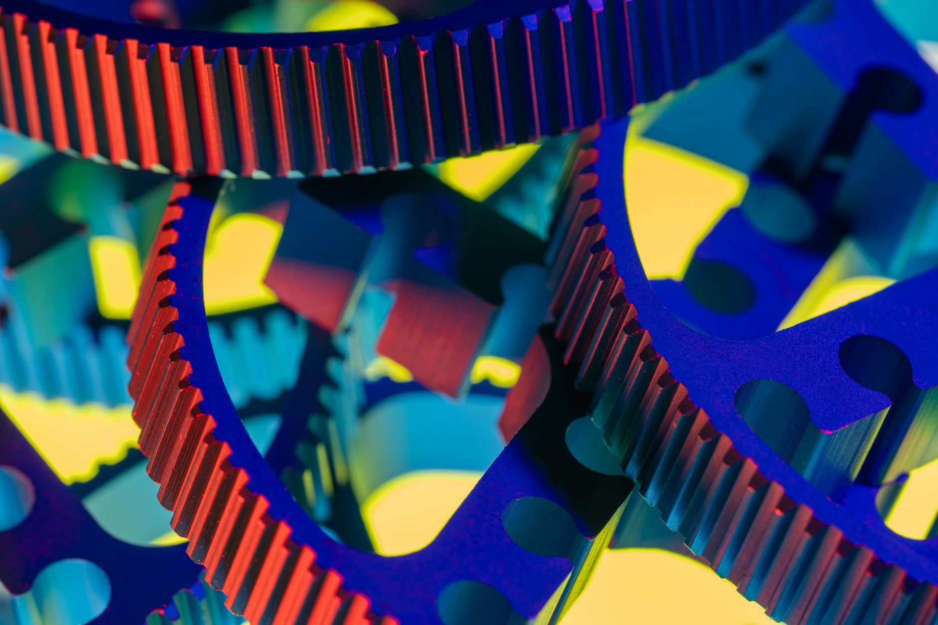Close-up of vibrant colored gears illustrating precision engineering and technology.