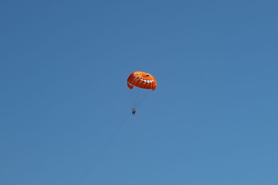 Orange parasail against clear blue sky in Primorsko-goranska, Croatia.