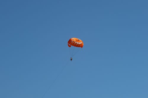 Free Orange parasail against clear blue sky in Primorsko-goranska, Croatia. Stock Photo