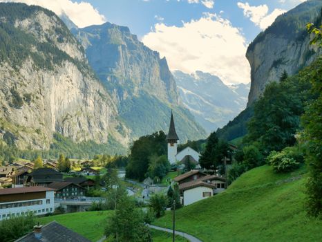 Stunning view of Lauterbrunnen Valley with mountains and a church in Switzerland.
