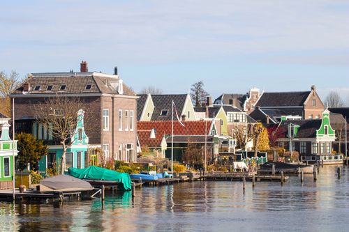 Free Beautiful traditional Dutch houses by the water in Zaandam, showcasing colorful architecture and tranquil surroundings. Stock Photo