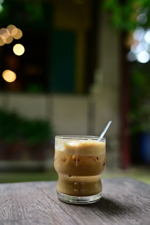 Free A delicious iced coffee served with frothy cream in a cozy outdoor setting. Stock Photo